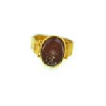 A child carnelian intaglio signet ring which is believed to be Roman,
