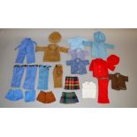 A collection of vintage dolls clothing including caps, two kilts, trousers etc.