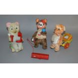 Three unboxed vintage battery operated tinplate toys including a Walking Bear pulling a tinplate