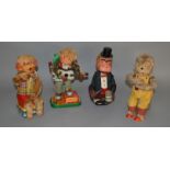 Four unboxed vintage battery operated tinplate toys including a Monkey Musician figure on tinplate