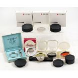 Collection of Leica Filters, Caps, etc. To include a black Leica FODIS clip-on rangefinder.
