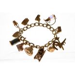 A 9ct H/M charm bracelet, the twelve charms all H/M 9ct, approx gross weight 69.8gms