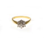An 18ct H/M diamond cluster ring, the seven round brilliant cut diamonds total approx 0.50cts,