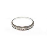 An 18ct H/M diamond half eternity ring, the graduated round brilliant cut diamonds total approx 0.