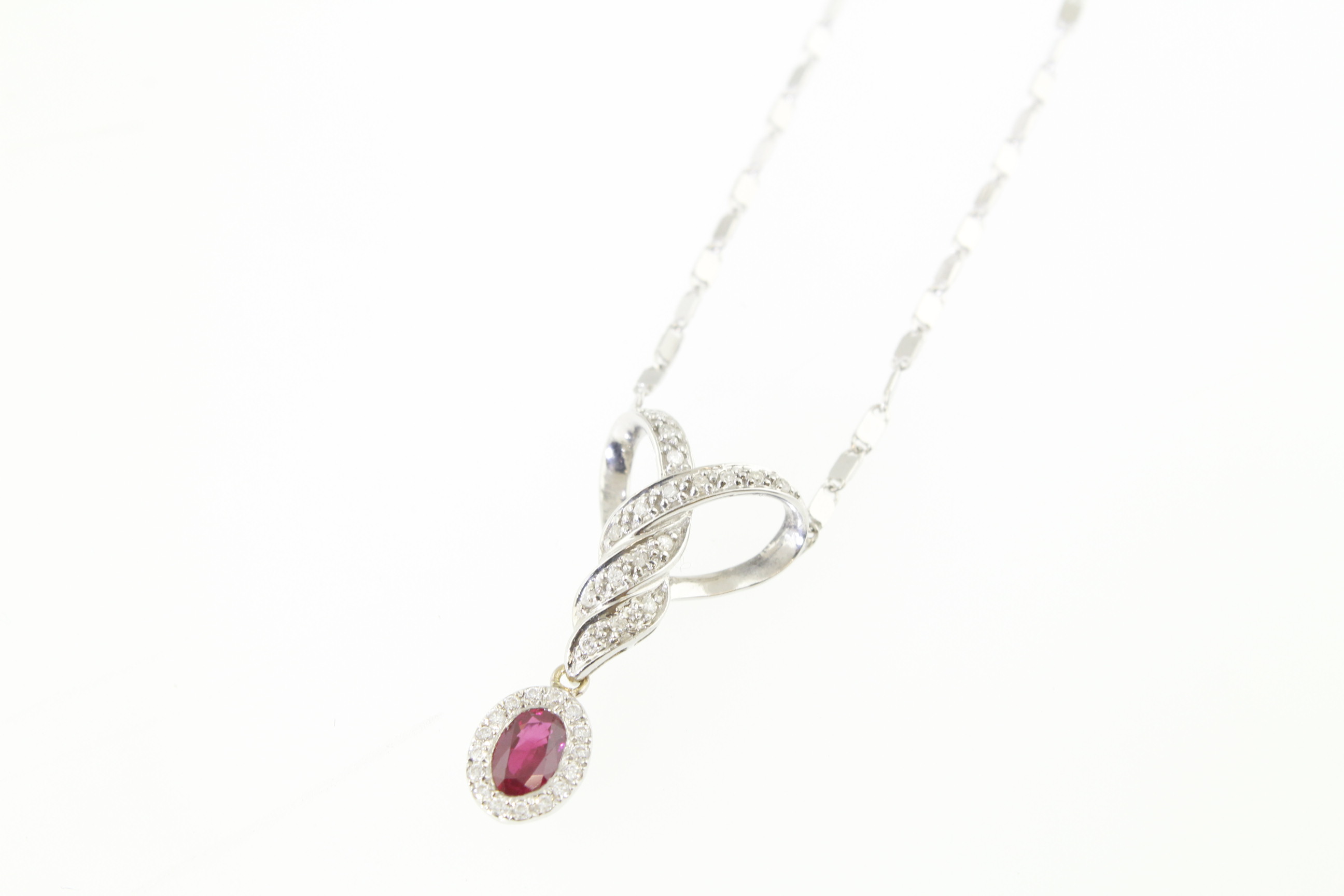A ruby & diamond pendant H/M 14ct, suspended by a 9ct H/M chain, the oval pigeon blood red ruby - Image 2 of 2