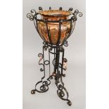 An Art Nouveau or Arts & Crafts wrought-iron Jardiniere with copper leaf details and copper plant-