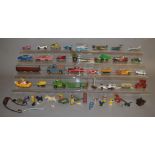 A mixed group of unboxed diecast, plastic and tinplate toys by Dinky, Matchbox and others with