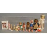 An assortment of unboxed porcelain, composition and vinyl dolls, the largest of which is an A.M.