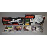 A boxed Super Nintendo Entertainment System together with a boxed Nintendo Scope 6 and a small