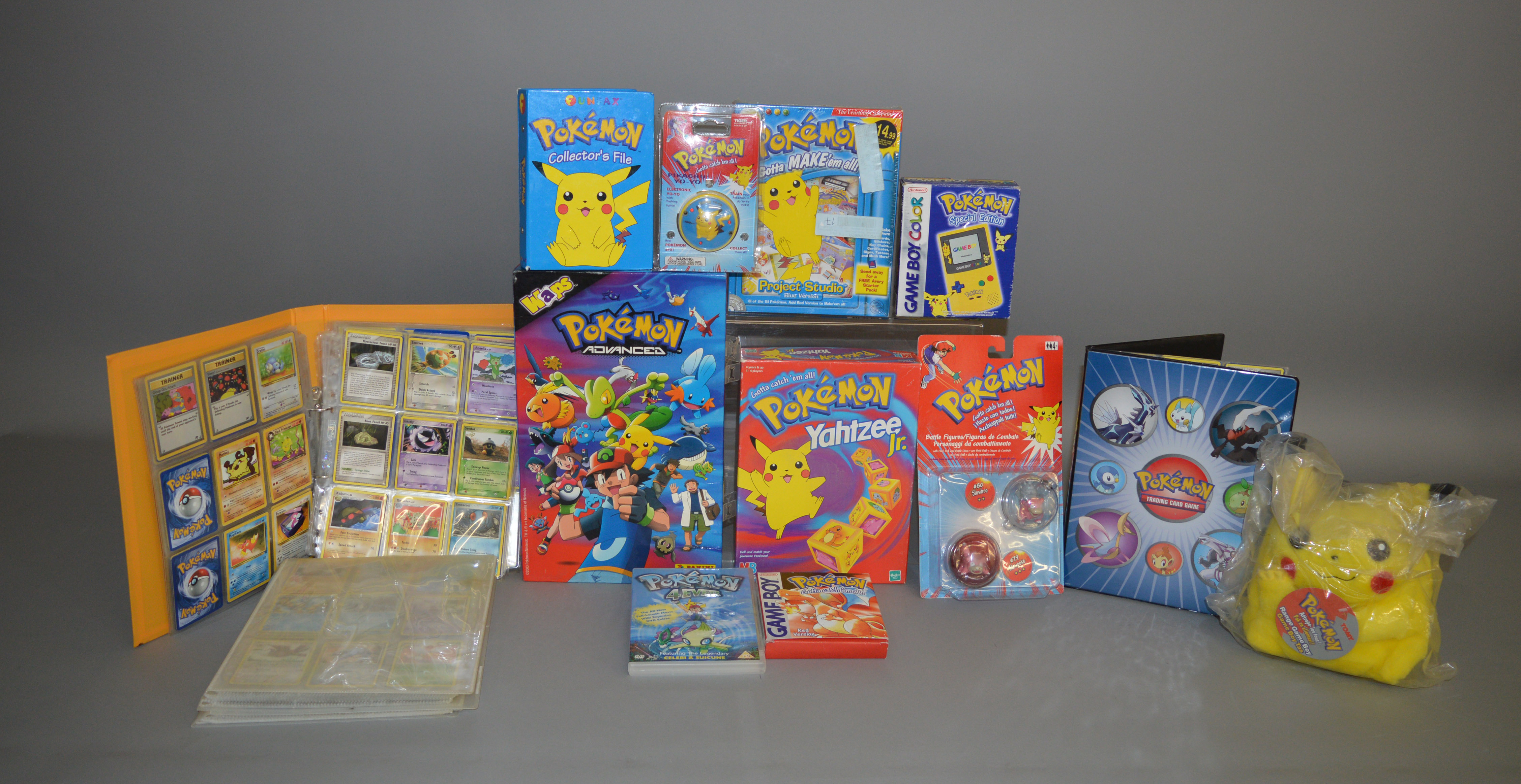 A mixed lot of Pokemon items, which includes; Game boy Color, Trading cards etc