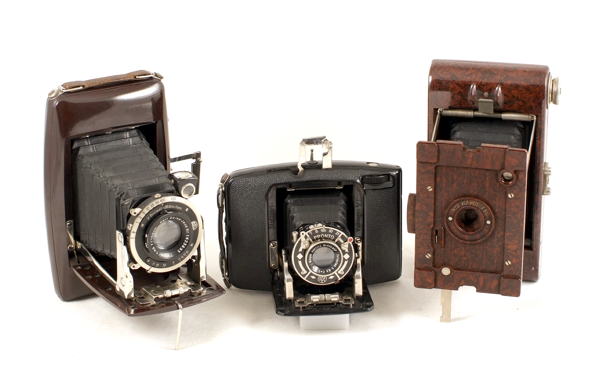 Group of Three Folding Bakelite Roll Film Cameras. Comprising two uncommon Ebner cameras (both