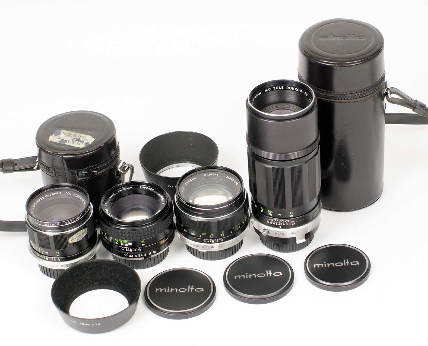 Four Early Minolta Rokkor MD Fit Lenses. Comprising HG 35mm f2.8 (filter stuck) with hood and