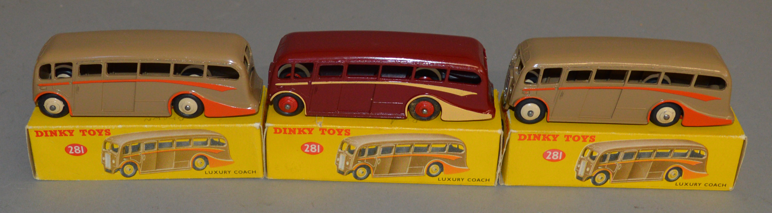 3 boxed Dinky Toys 281 Luxury Coach models - Maroon with cream flashes and red hubs together with