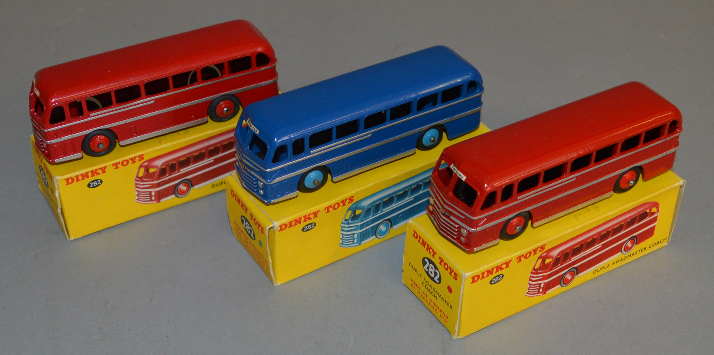 3 boxed Dinky Toys 282 Duple Roadmaster Coach models - two in Red with Silver Coachlines and red