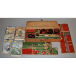 A quantity of vintage red and green Meccano parts housed in a wooden box together with a small