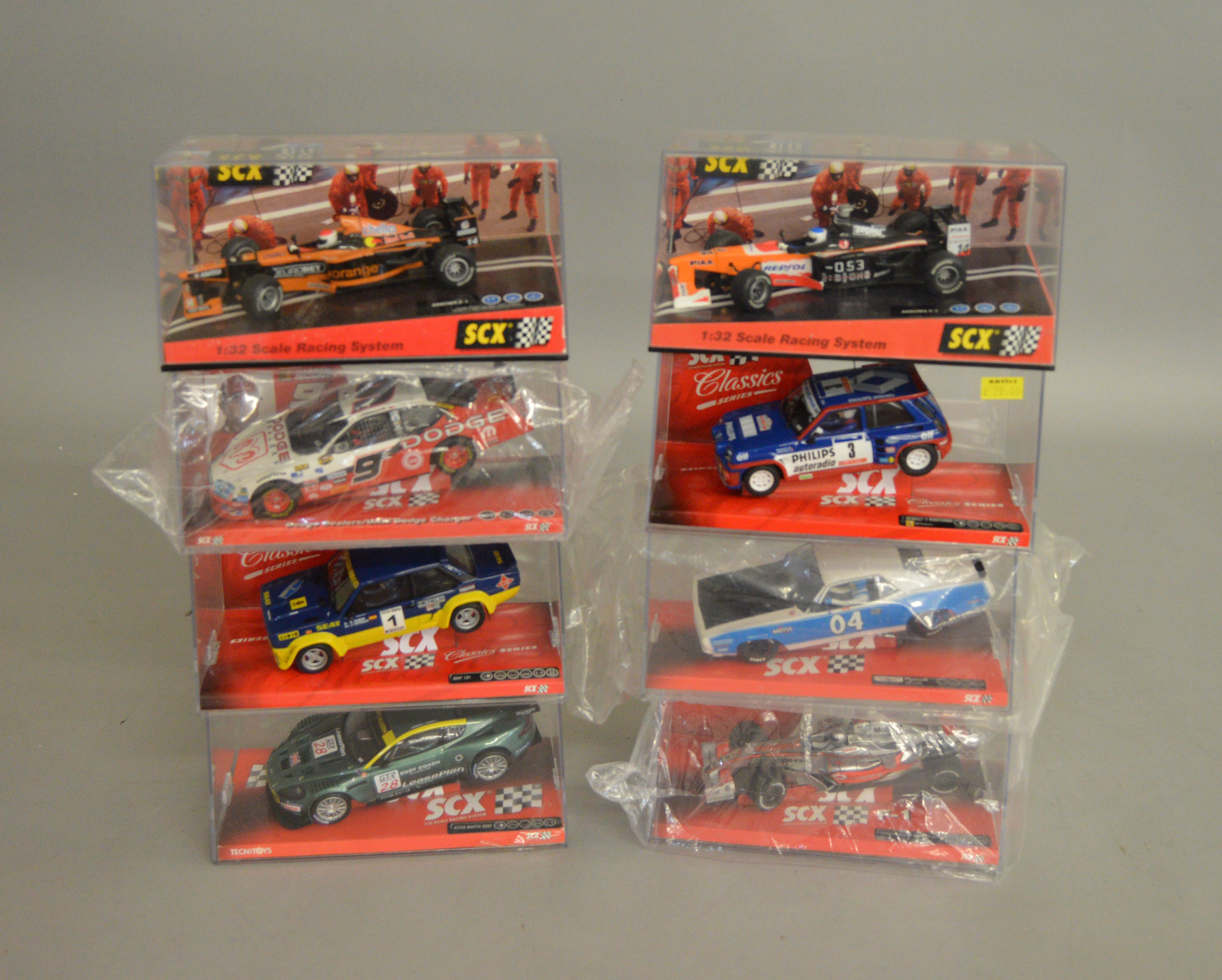 8 boxed SCX slot cars, which includes; #62060 Aston Martin DBR-9, #62680 Dodge Charger etc (8)