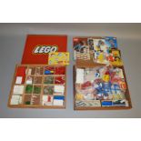 2 vintage wooden Lego set boxes one of which has a red sliding hardboard lid bearing the Lego logo