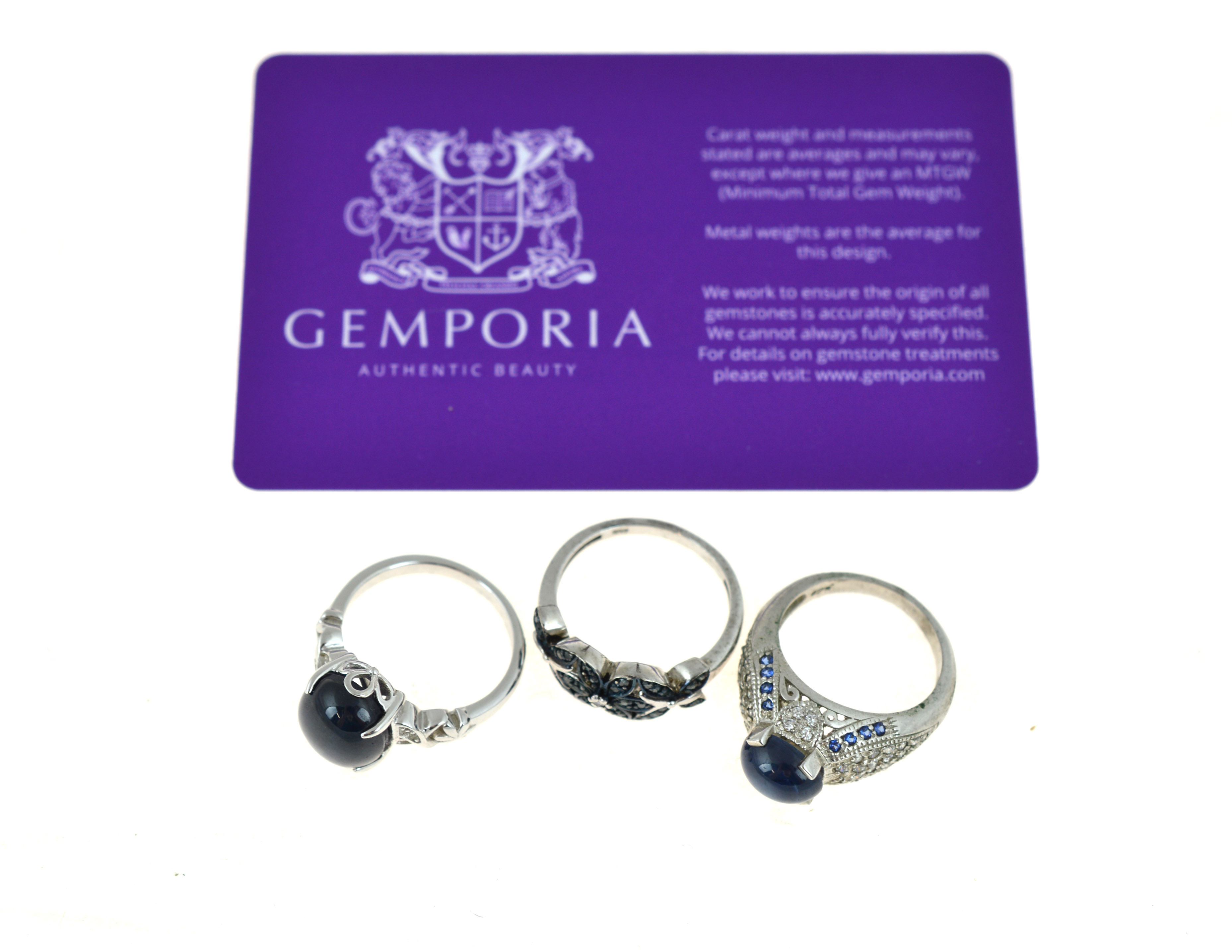 Three silver gem set rings to include one set with a Madagascan blue star sapphire & white topaz