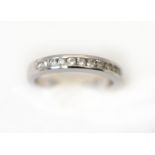 An 18ct white gold H/M diamond set half eternity ring, estimated total diamond weight .025cts,