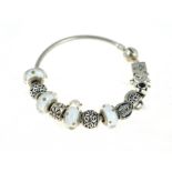 PANDORA - A silver Pandora bangle, with twelve Pandora charms, approx gross weight 43.6gms