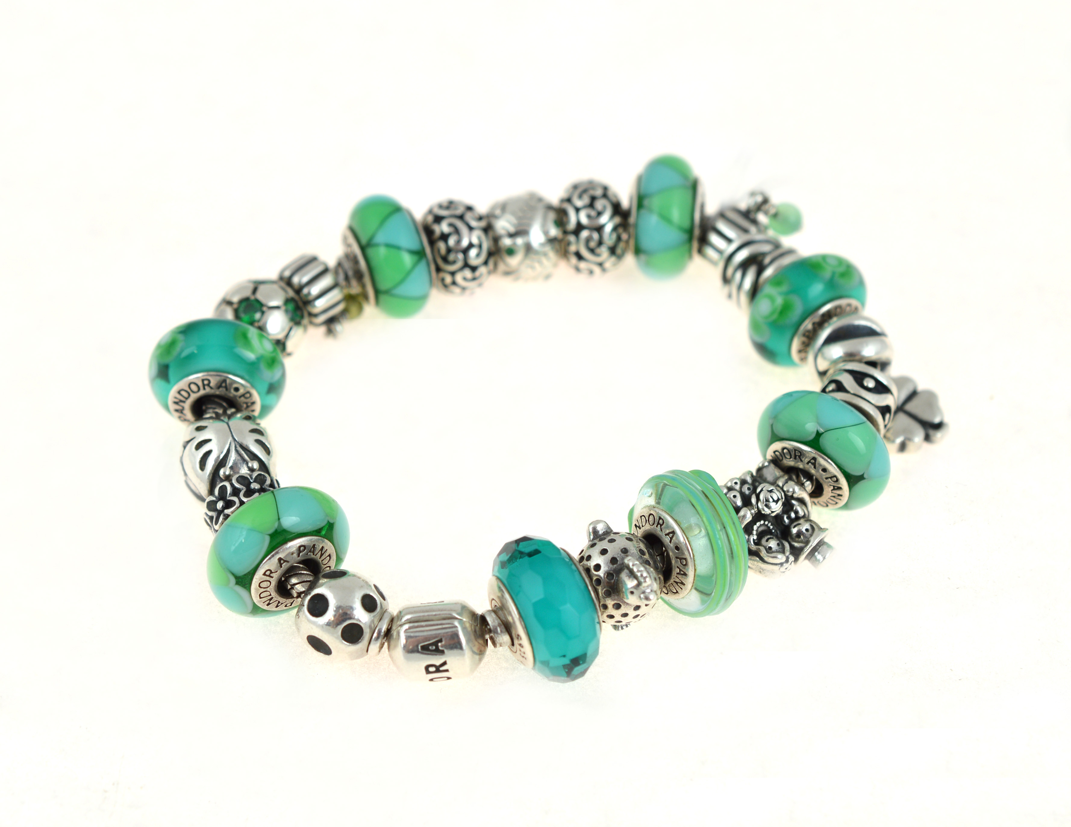 PANDORA - A silver Pandora bracelet, with twenty two Pandora charms/stoppers, approx gross weight