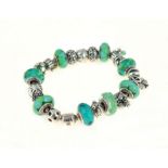 PANDORA - A silver Pandora bracelet, with twenty two Pandora charms/stoppers, approx gross weight