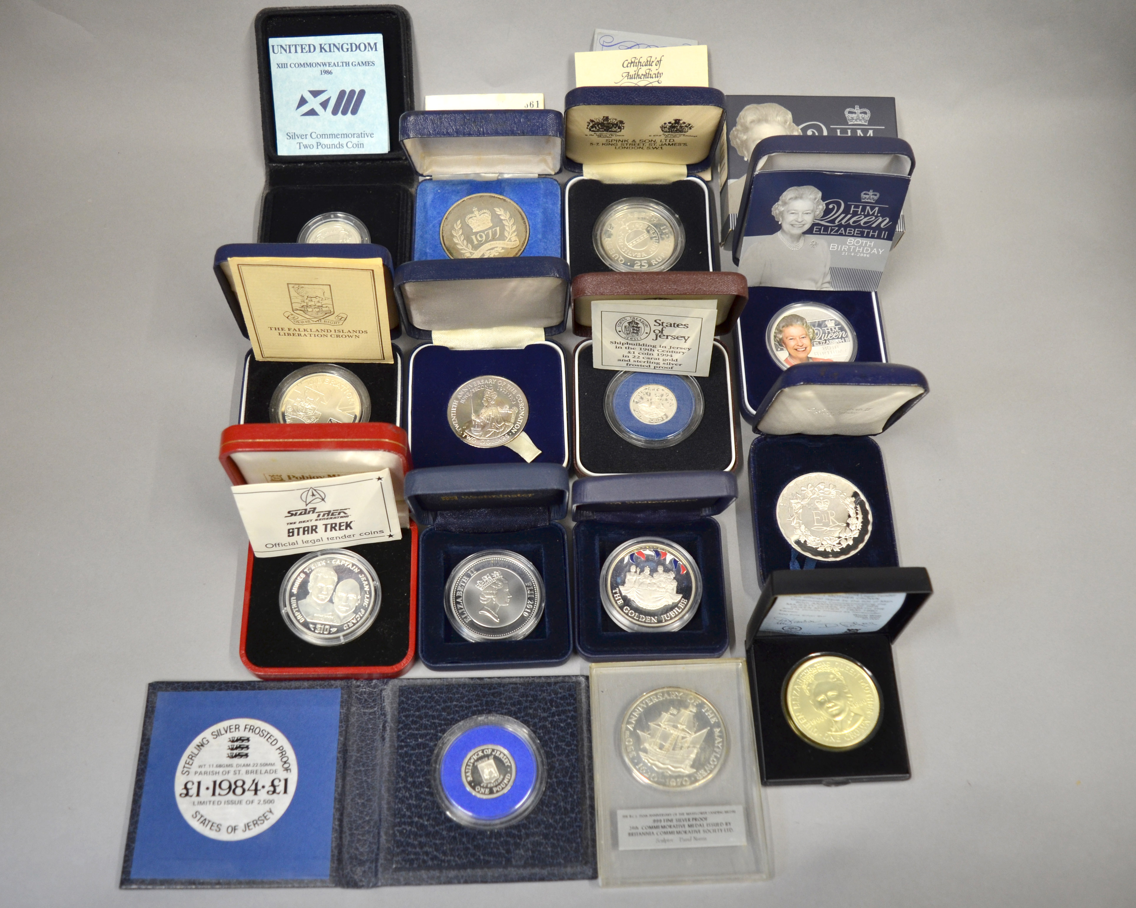 A boxed quantity of silver proof coins/medallions to include Spink & Son 25 Rupee commemorating