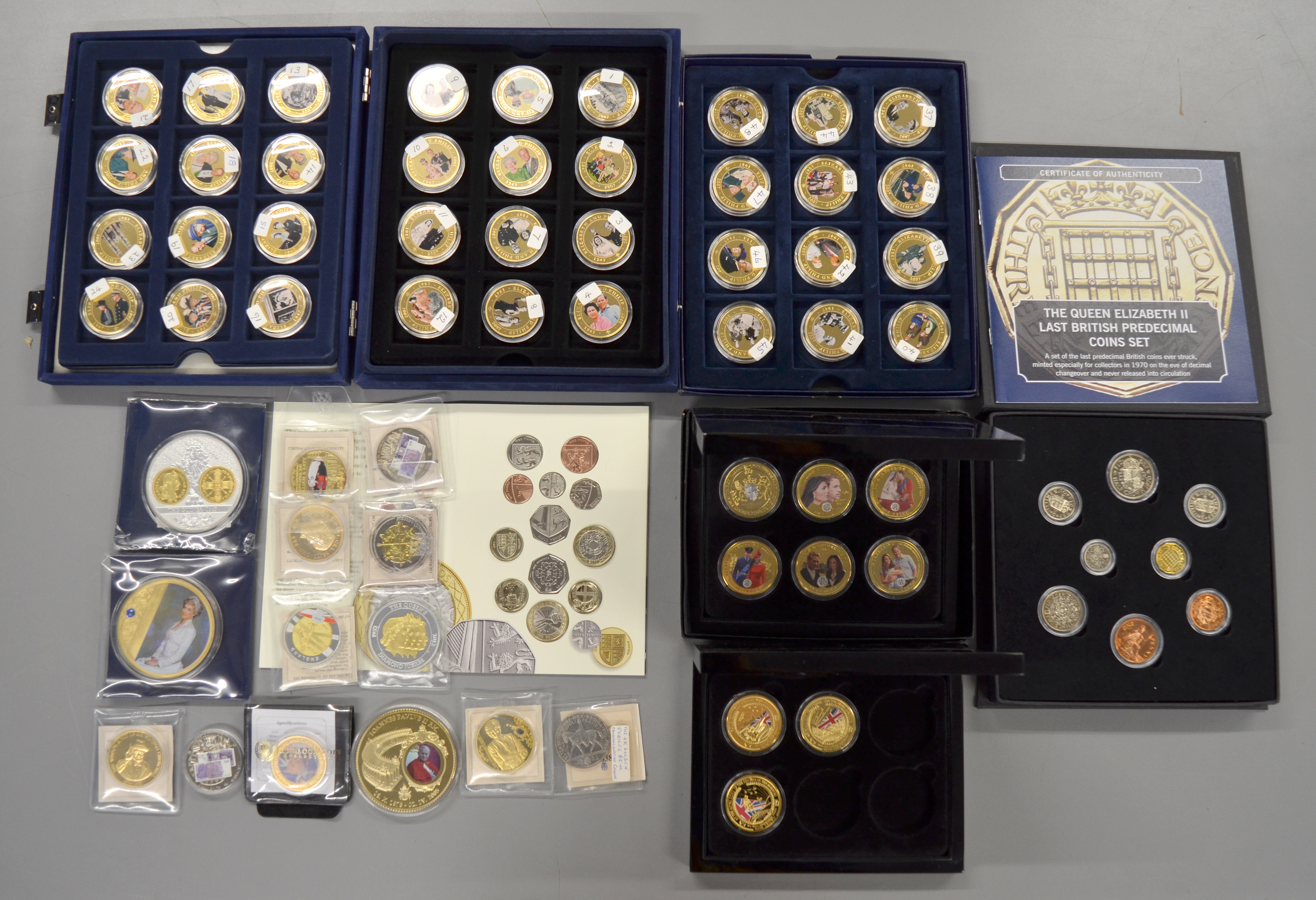 A boxed quantity of commemorative coins/medallions to include forty eight boxed $1 Dollar Cook
