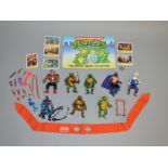 8 Teenage Mutant Ninja Turtle figures by Playmates along with some weapons, a complete medal