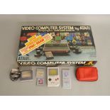 Atari Super System in original box along with a Gameboy and accessories.
