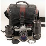 Canon AE-1 Four-Lens Outfit. Comprising AE-1 body with FAST FD 35mm f2 SSC lens (condition 4/5F); FD