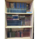 A collection of leather bound and other books on three shelves