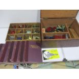 A wooden chest containing a large collection of vintage Meccano along with six volumes of Meccano