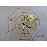 A Spectra crystal ( by Swarovski) gold plated spider in its web and a similar butterfly