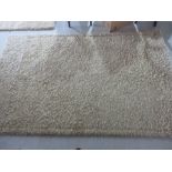 A thick pile beige rug