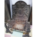 A cast iron fire back, grate and fire dogs ( fire back cracked and repaired)