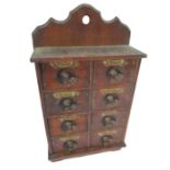 A Victorian spice cabinet with eight labelled drawers