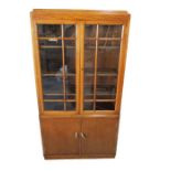 An oak Art Deco display cabinet with cupboard under