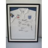 A 2009/10 replica England football shirt, framed and signed by various memebers of the team