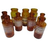 Nine French amber glass chemists jars some with etched labelling