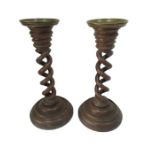 A pair of Victorian oak barley twist candlesticks with heavy brass sconces