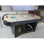 A Power Puck air hockey table