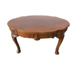 A shaped walnut veneered coffee table with scallop design