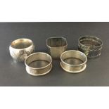 Four hallmarked silver napkin rings and one other.