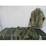 A British Army military jacket and a collection of various military trousers