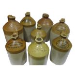 Eight stoneware cider jugs all printed/stamped for Axminster