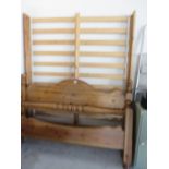 A pine double bed frame with slats