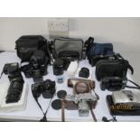 A Canon Rangemaster camera and a collection of other cameras and lenses including, Vivitar etc.