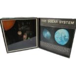 A display of the solar system in carry case- probably a teaching aid