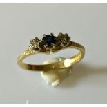 An 18ct gold ring with sapphire and diamonds.